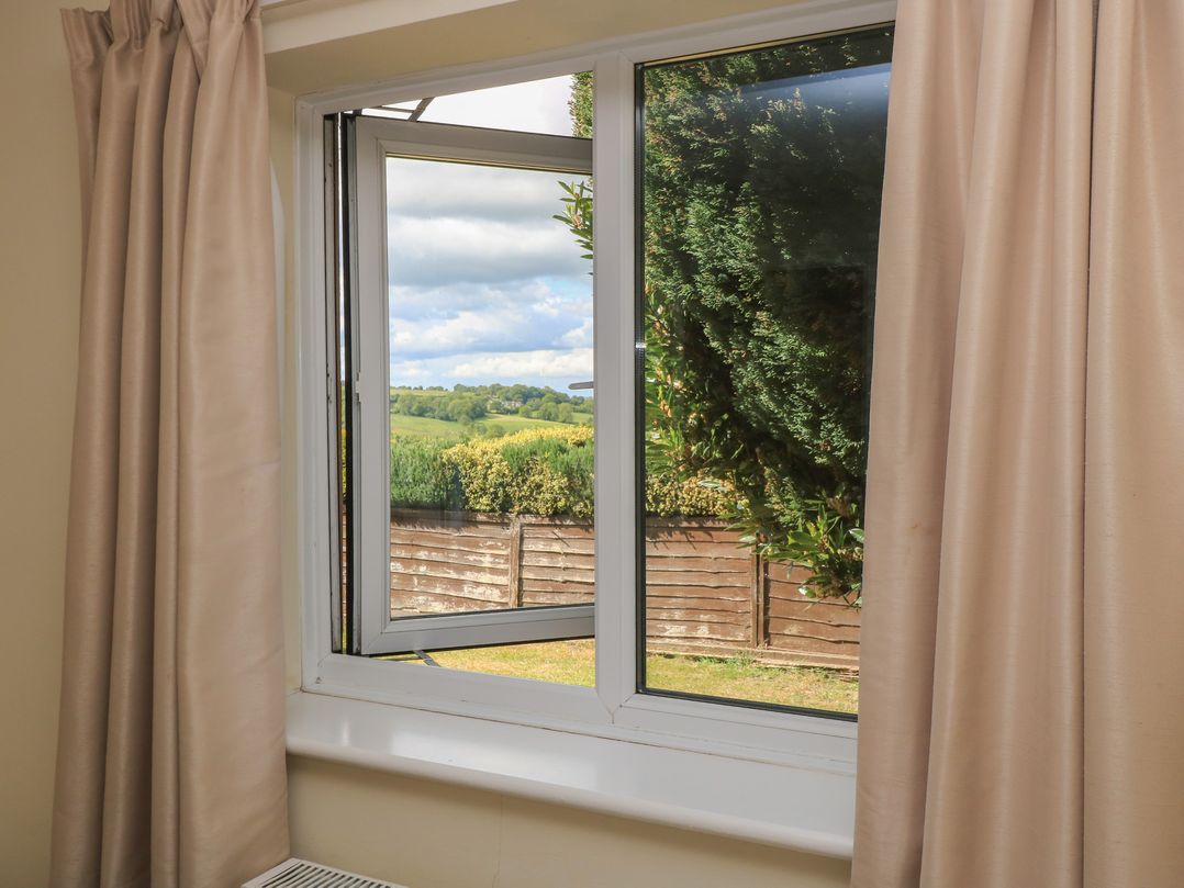 A view from a window with a curtain at Ryecross Farm Cottage, Shaftesbury