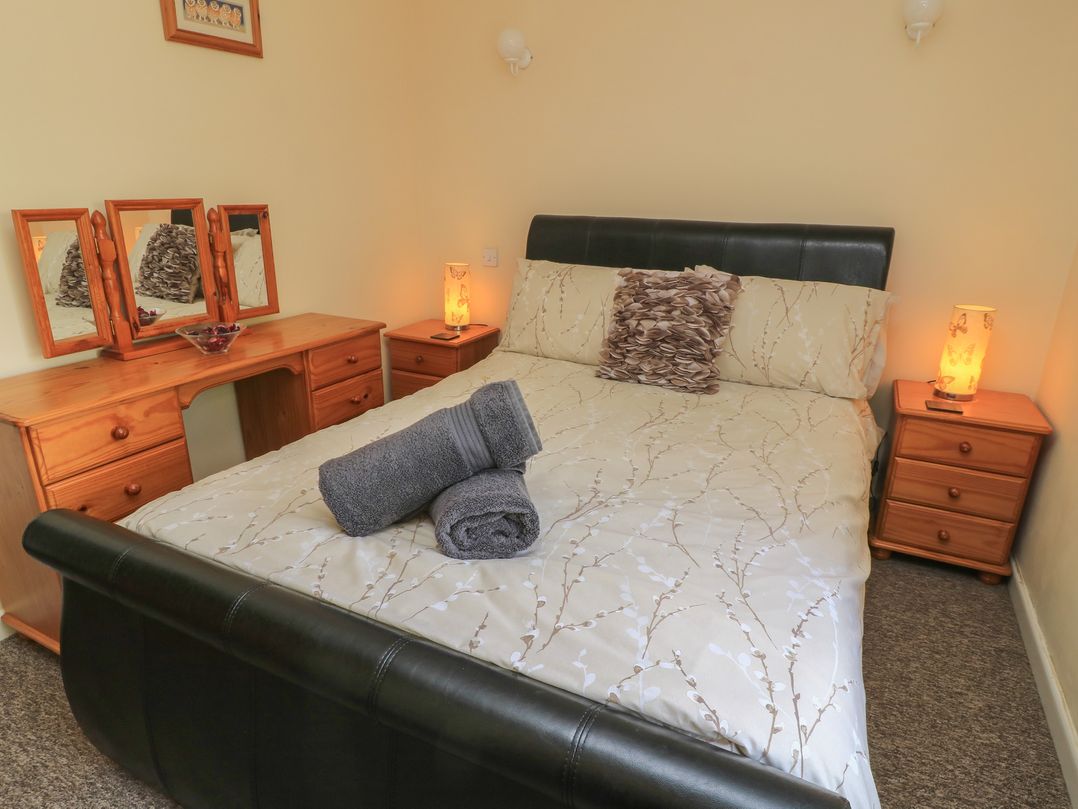 A bedroom with a double bed and dressing table at Ryecross Farm Cottage in Shaftesbury