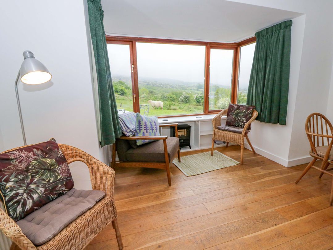 A snug with two chairs and a table near a window at Ceunant near Newport