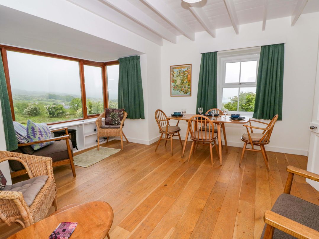 A dining room with a table and chairs at Ceunant near Newport