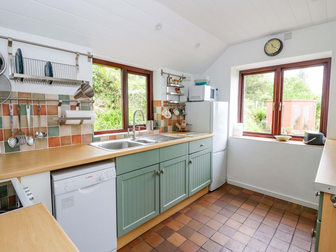 A kitchen with a sink and dishwasher at Ceunant near Newport