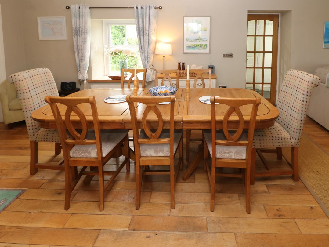 A dining room with a table and chairs at North Studdock Cottage Angle near Pembroke