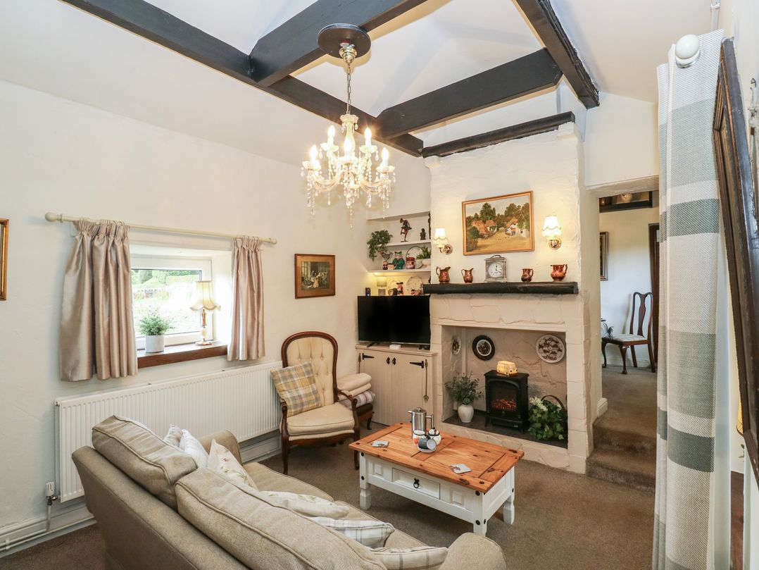 A living room with a sofa and coffee table at Prospect Cottage in Ripponden