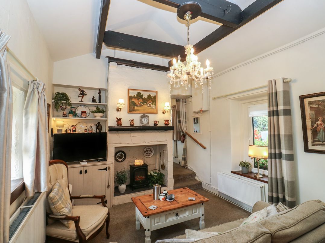 A living room with a coffee table and sofa at Prospect Cottage in Ripponden