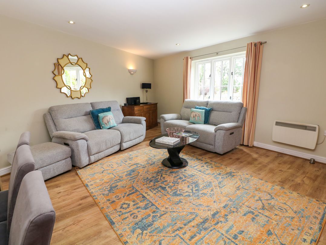A living room with a sofa, chairs, and a coffee table at Hartington in Darley Moor near Two Dales