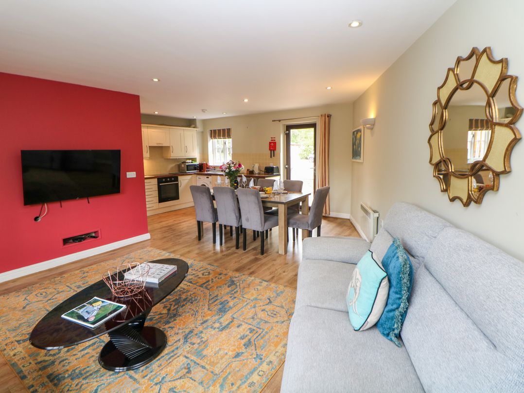A living room with a sofa and dining area at Hartington in Darley Moor near Two Dales