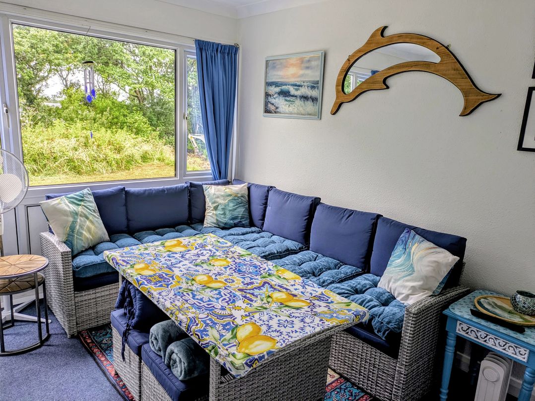 A snug area with a sofa and table at 21 The Glade in Kilkhampton