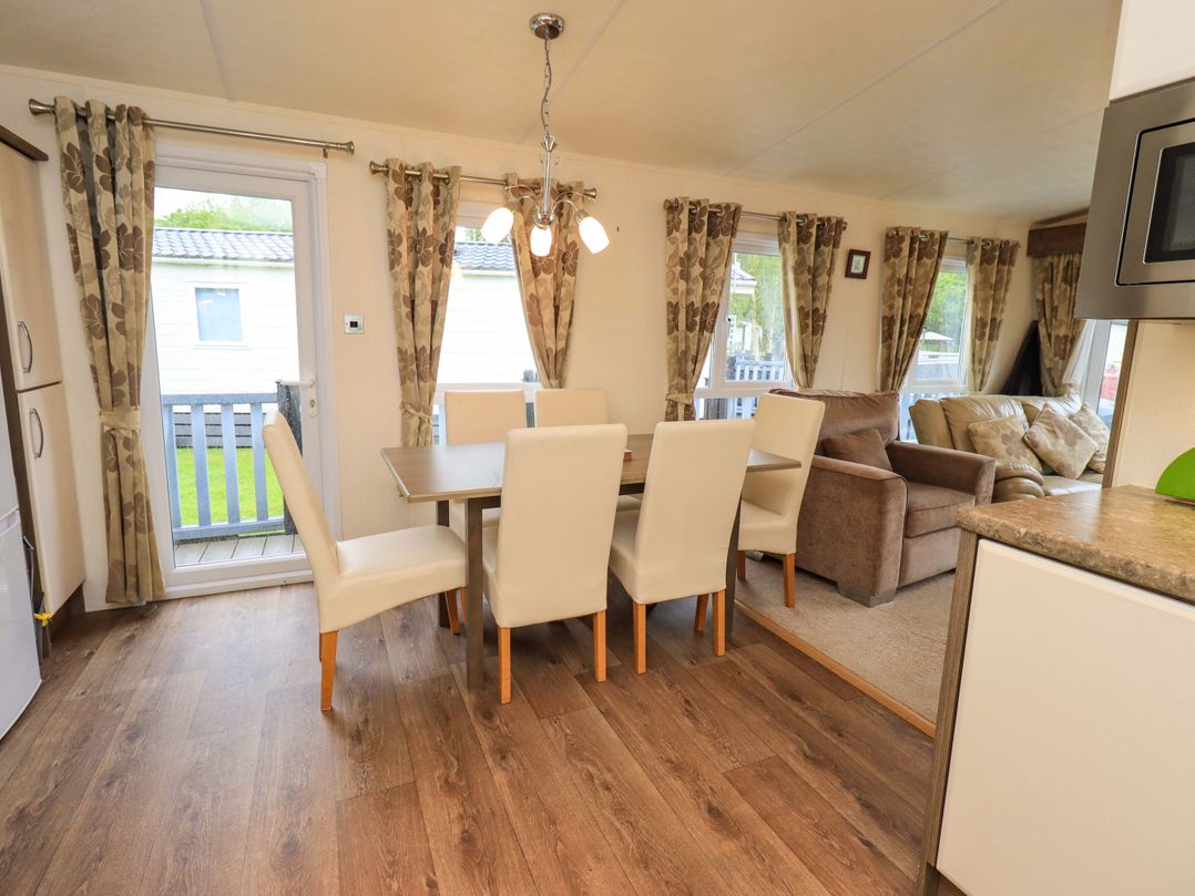 A dining room with a table and chairs at 41, Grandma's Cottage South Lakeland Leisure Village near Carnforth