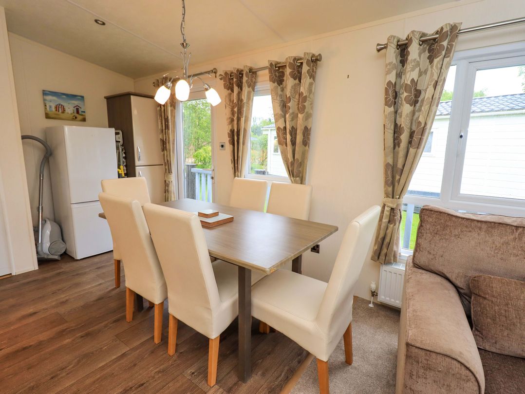 A dining area with a table and chairs at 41, Grandma's Cottage South Lakeland Leisure Village near Carnforth