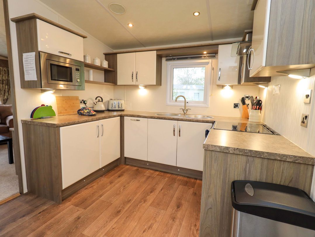 A kitchen with cabinetry and appliances at 41, Grandma's Cottage South Lakeland Leisure Village near Carnforth
