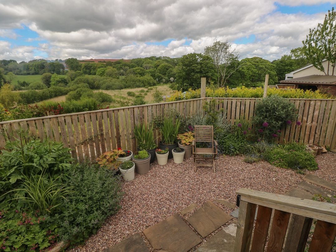A garden with potted plants and a view of the landscape at Garden View in Pembroke