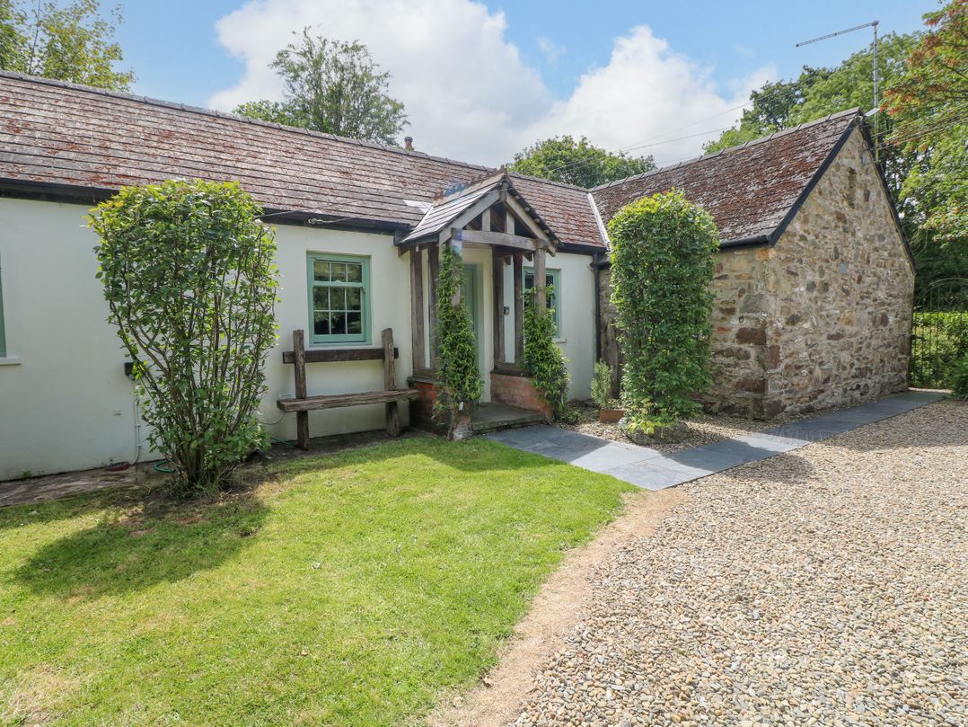 A house with a stone wall and garden at Glas y Dorlan Nevern near Newport, Pembrokeshire