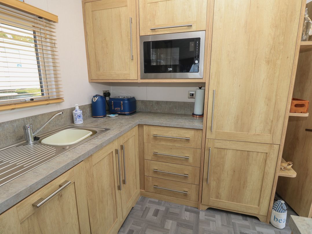 A kitchen with cabinets and a sink at 31 Crosswinds in Bembridge