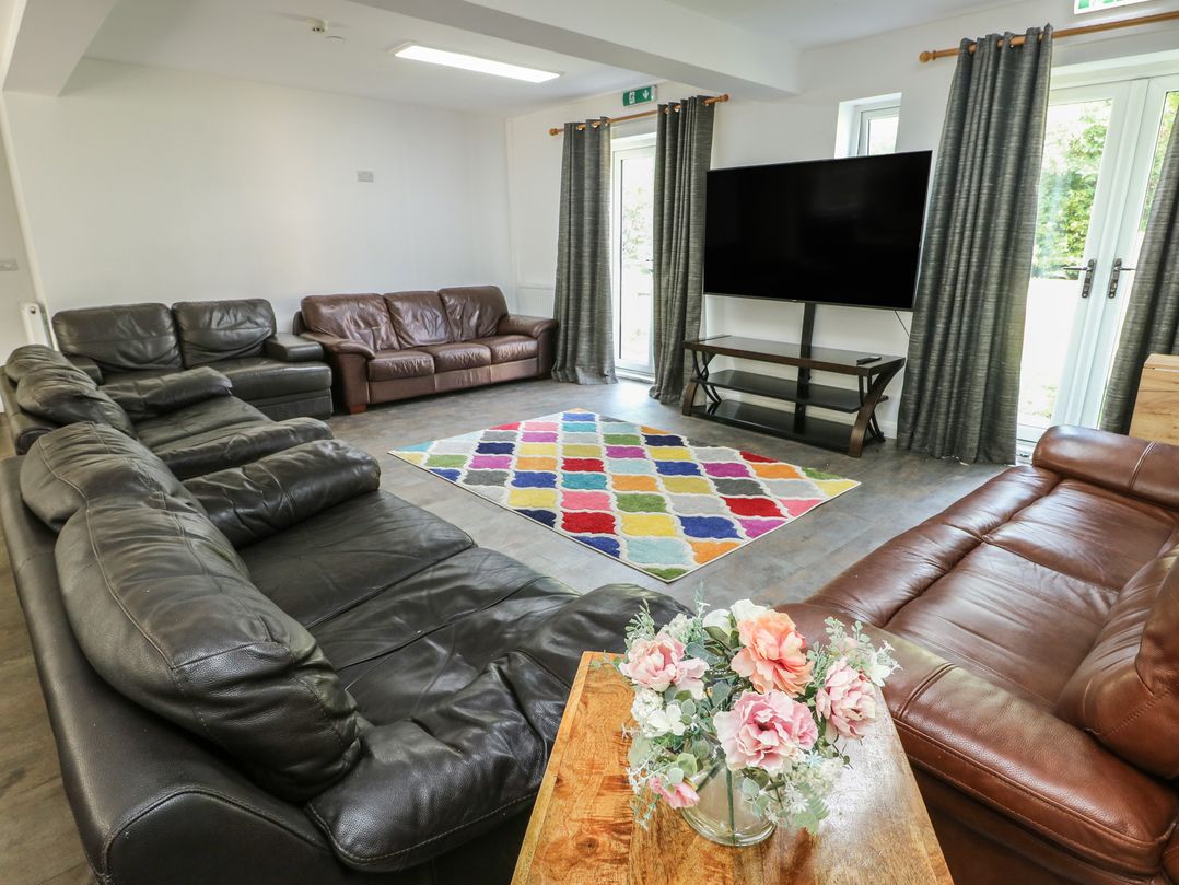 A living room with sofas and a television at The Bevan in Bontnewydd, Gwynedd