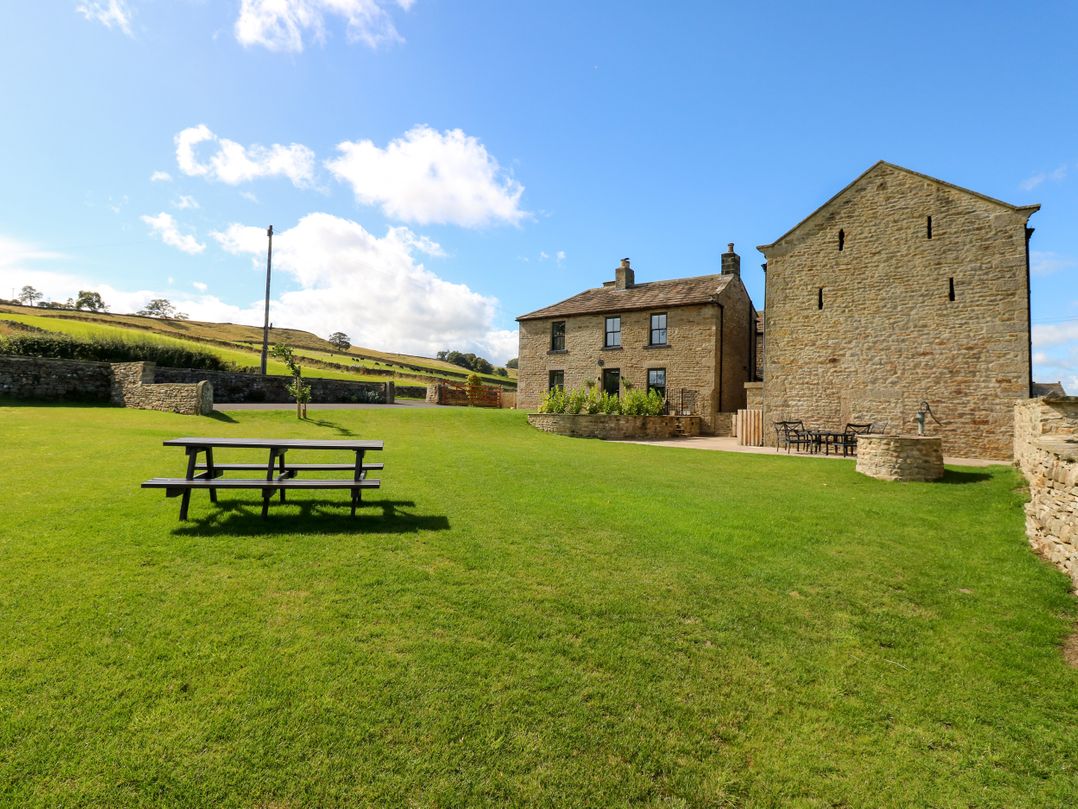 An outdoor area with a stone house and barn at Eastfield Farm Mickleton, Teesdale