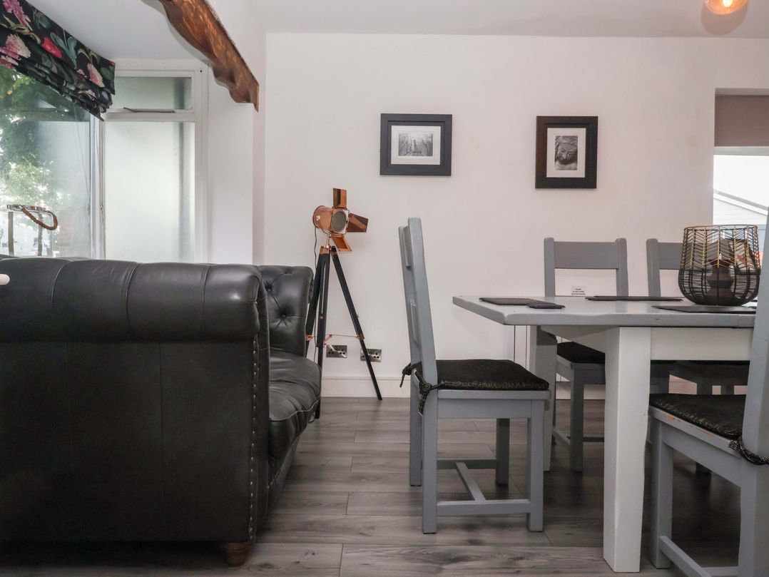 A dining room with a sofa and a dining table at Fox Retreat in Sherburn