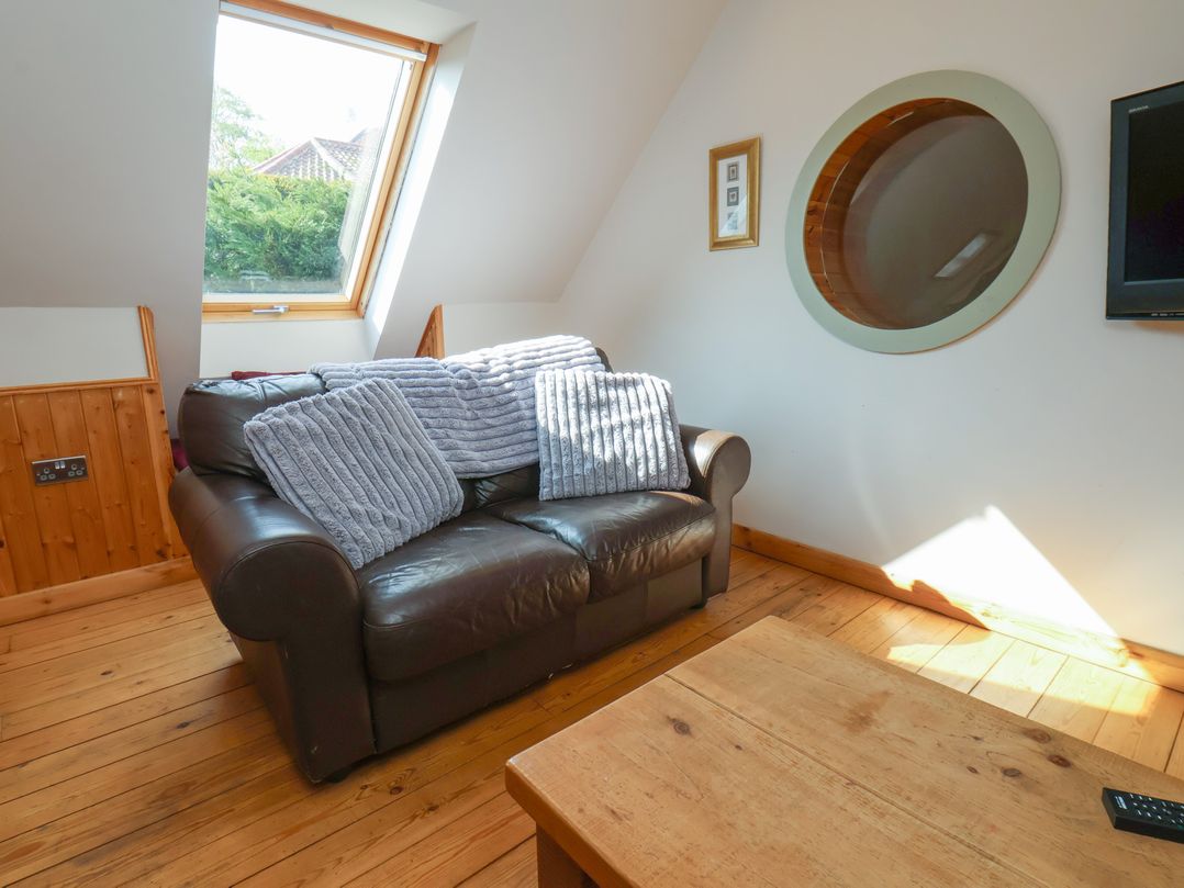 A living room with a sofa and coffee table at Horseshoe Cottage Ingleby Greenhow near Great Ayton