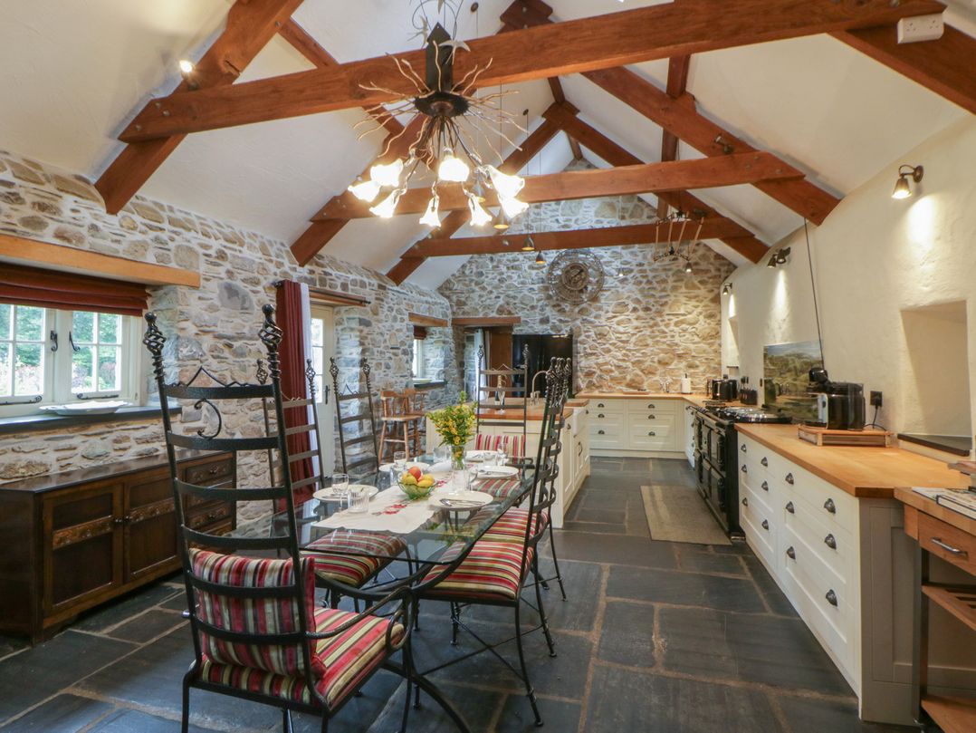 A kitchen with a table and chairs at St Dogwells Barn near Wolfscastle