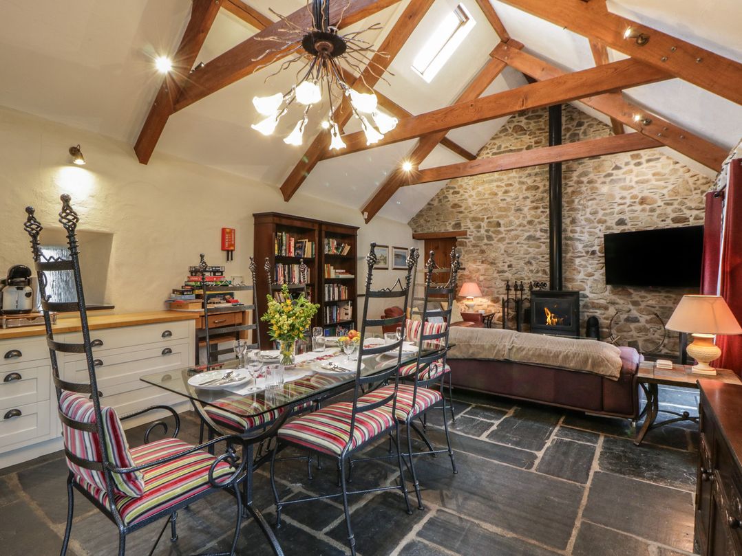 A dining room with a table and chairs at St Dogwells Barn near Wolfscastle