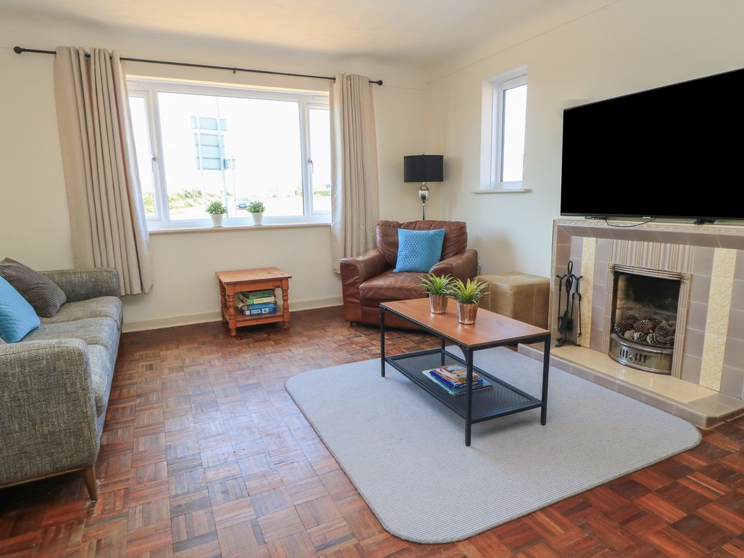 A living room with a sofa and coffee table at Bayview Cottage in Southbourne