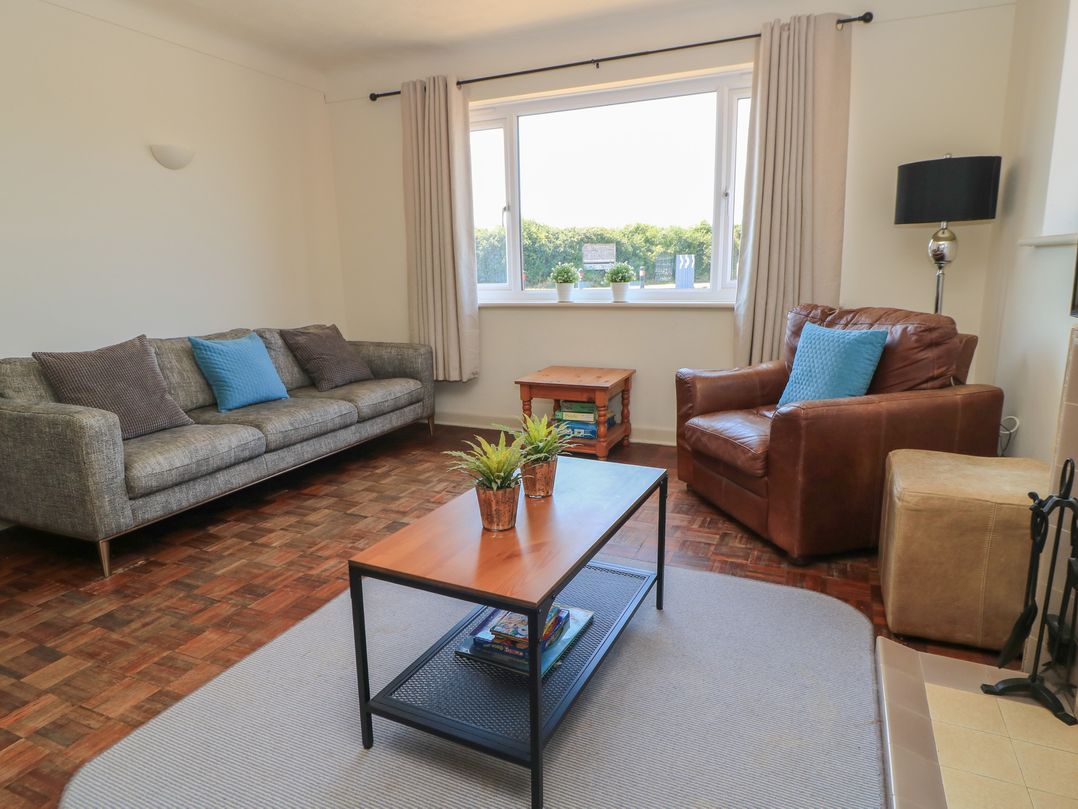 A living room with a coffee table and seating at Bayview Cottage in Southbourne