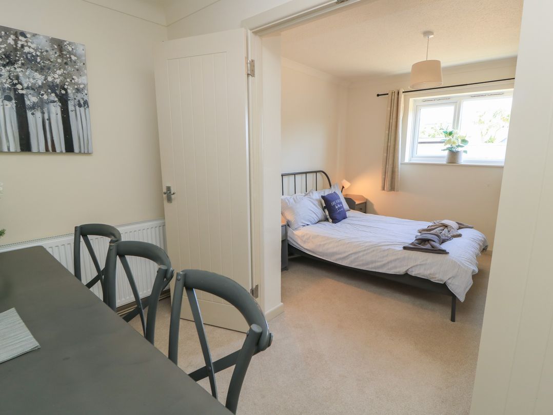 A bedroom with a bed and a window at Bayview Cottage in Southbourne