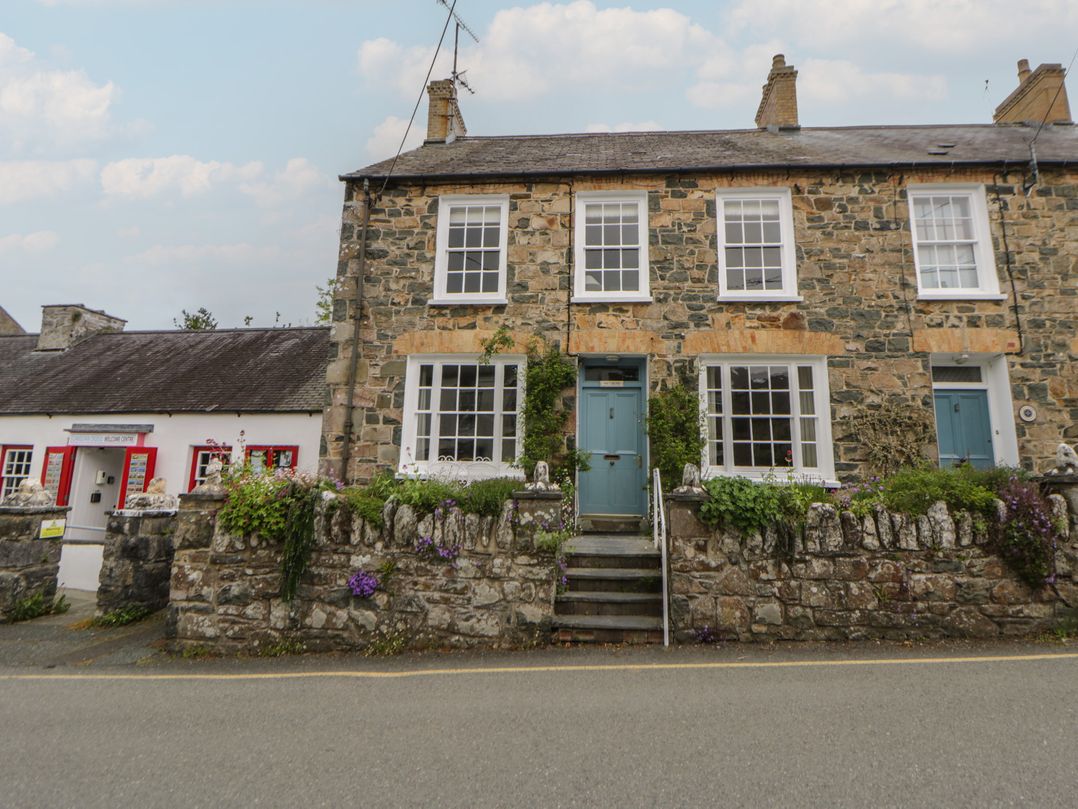 A stone house with a blue door and windows in Newport, Pembrokeshire