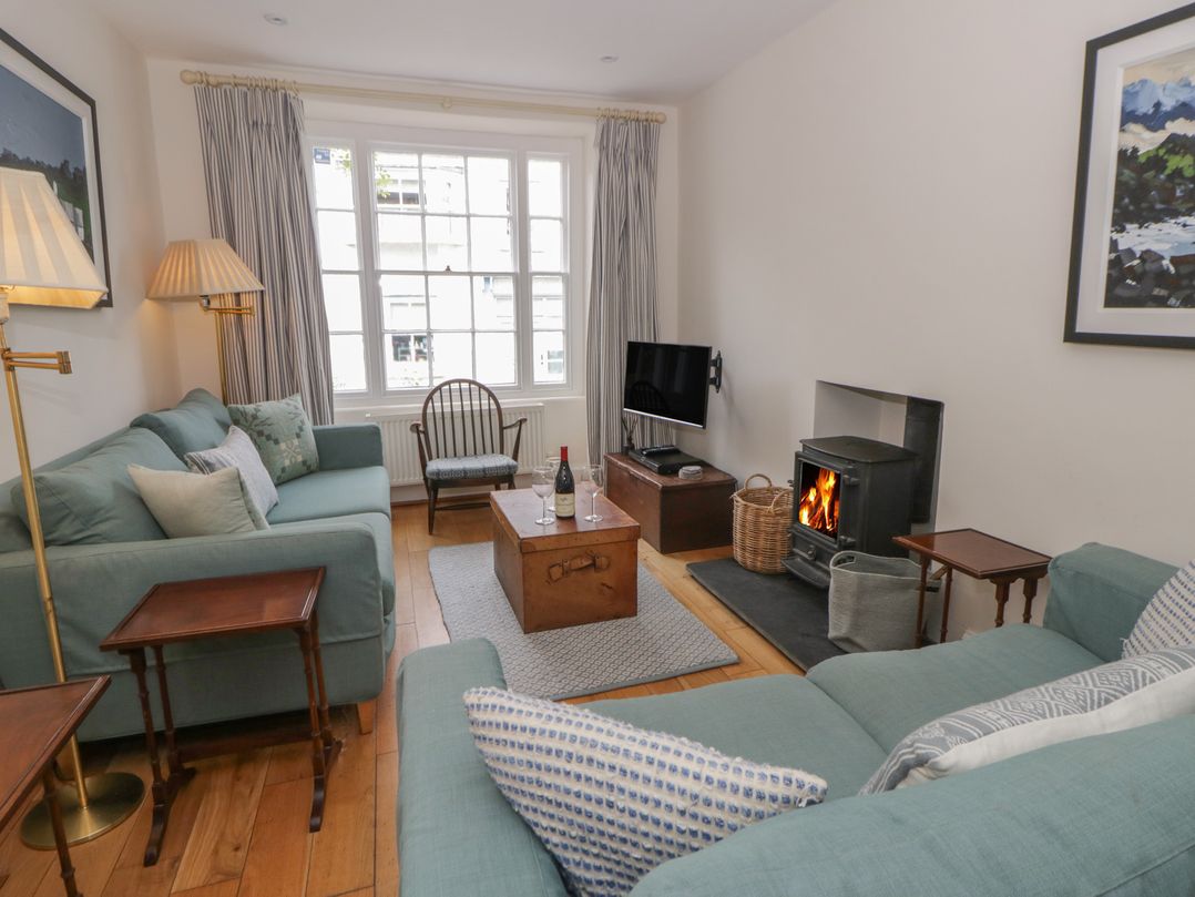 A living room with a sofa and a fireplace at Ty Clyd in Newport, Pembrokeshire