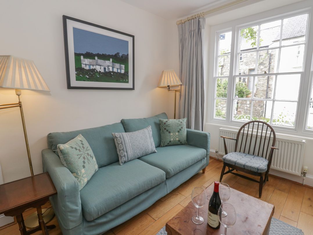 A living room with a sofa and table at Ty Clyd in Newport, Pembrokeshire