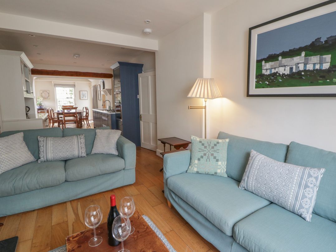 A living room with sofas and a dining area at Ty Clyd Newport, Pembrokeshire