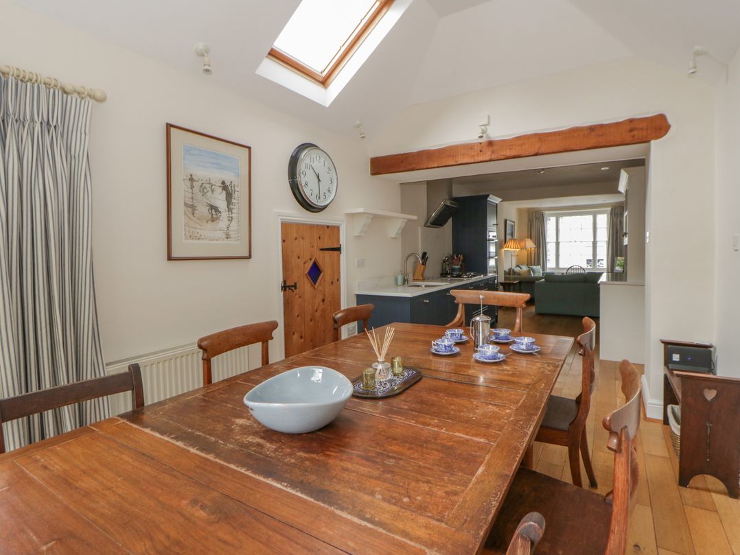 A dining room with a wooden table and chairs at Ty Clyd in Newport, Pembrokeshire