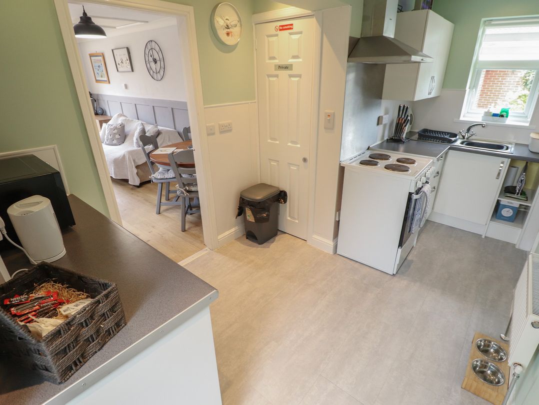 A kitchen with a microwave and stove at Southfields Annex Little Carlton near Louth
