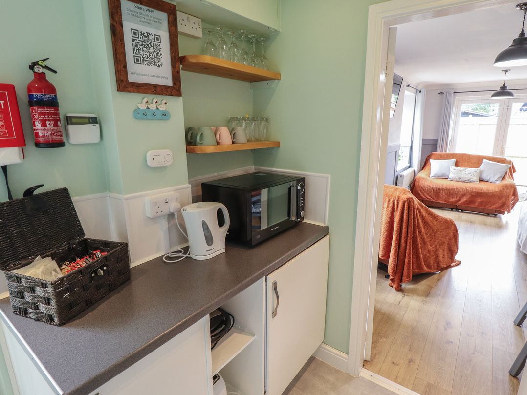 A kitchen with a microwave and kettle at Southfields Annex Little Carlton near Louth