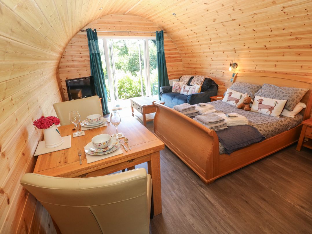 A bedroom with a bed and seating area at Lodge 2 near Pontyates