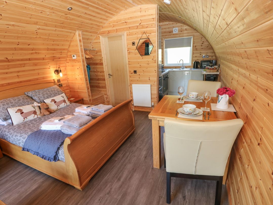 A studio with a bed and dining table at Lodge 2 near Pontyates