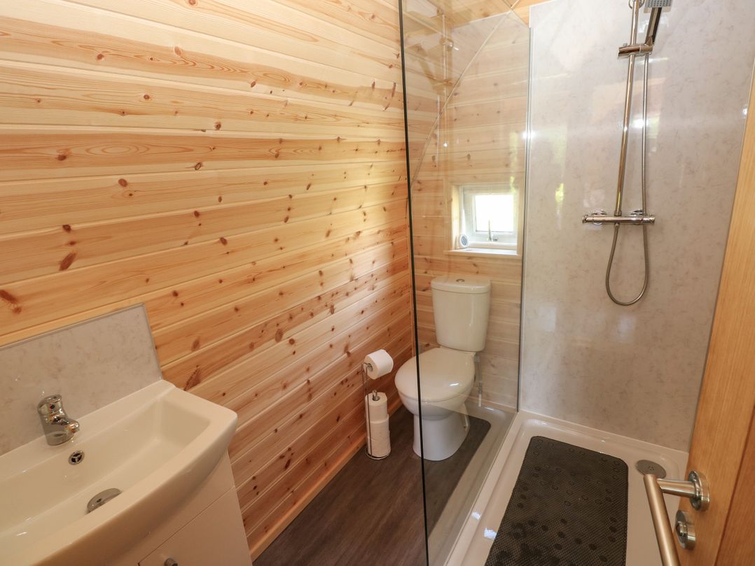 A bathroom with a shower and sink at Lodge 2 near Pontyates
