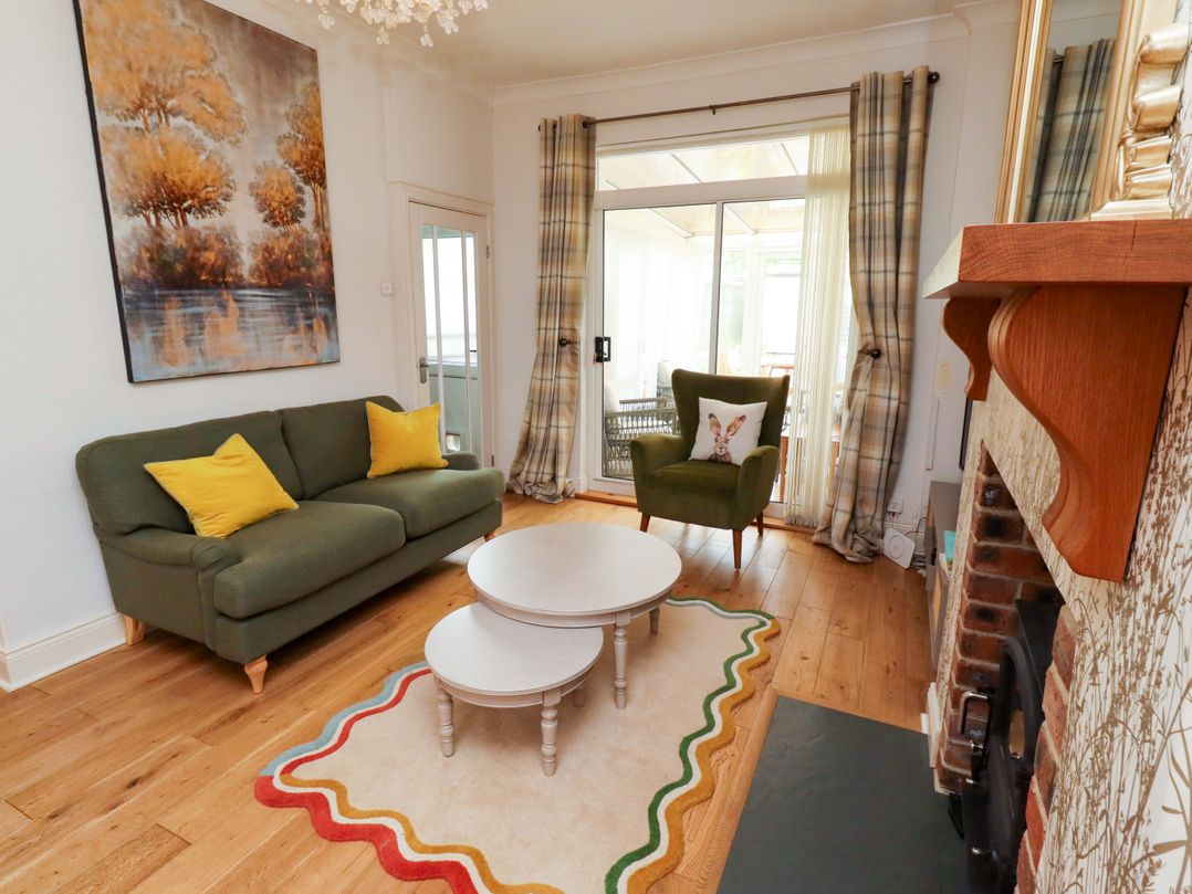 A living room with a sofa and coffee table at Rose Briar Cottage in Morpeth