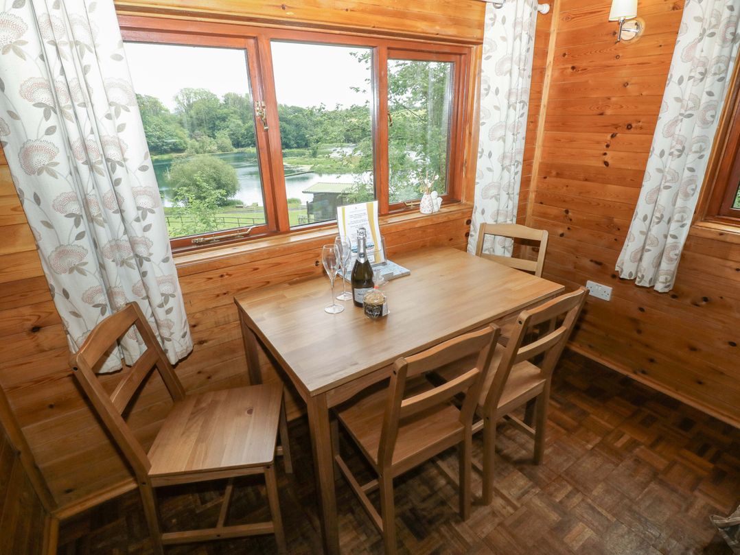 A dining room with a table and chairs at Ash Lodge near Mynydd Cerrig Porthyrhyd