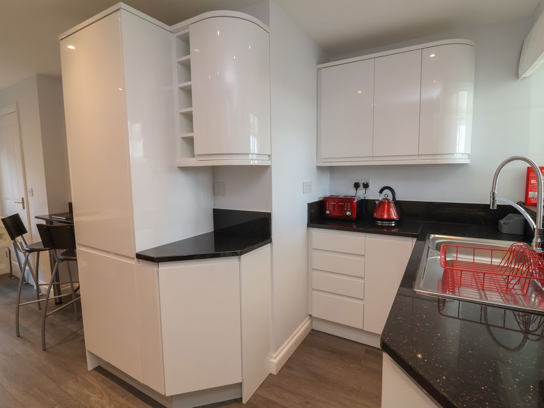 A kitchen with cabinets and appliances at Atlantic View Poundstock near Bude