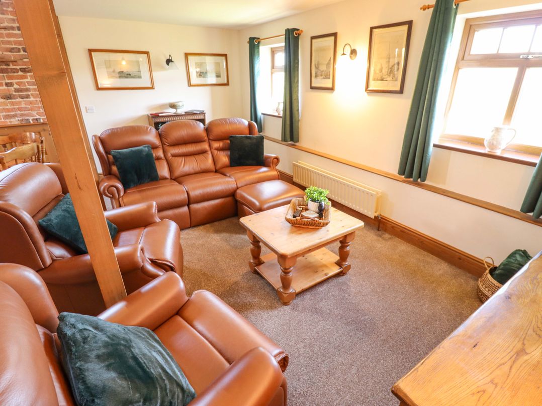 A living room with sofas and a coffee table at Barn Owl near Louth