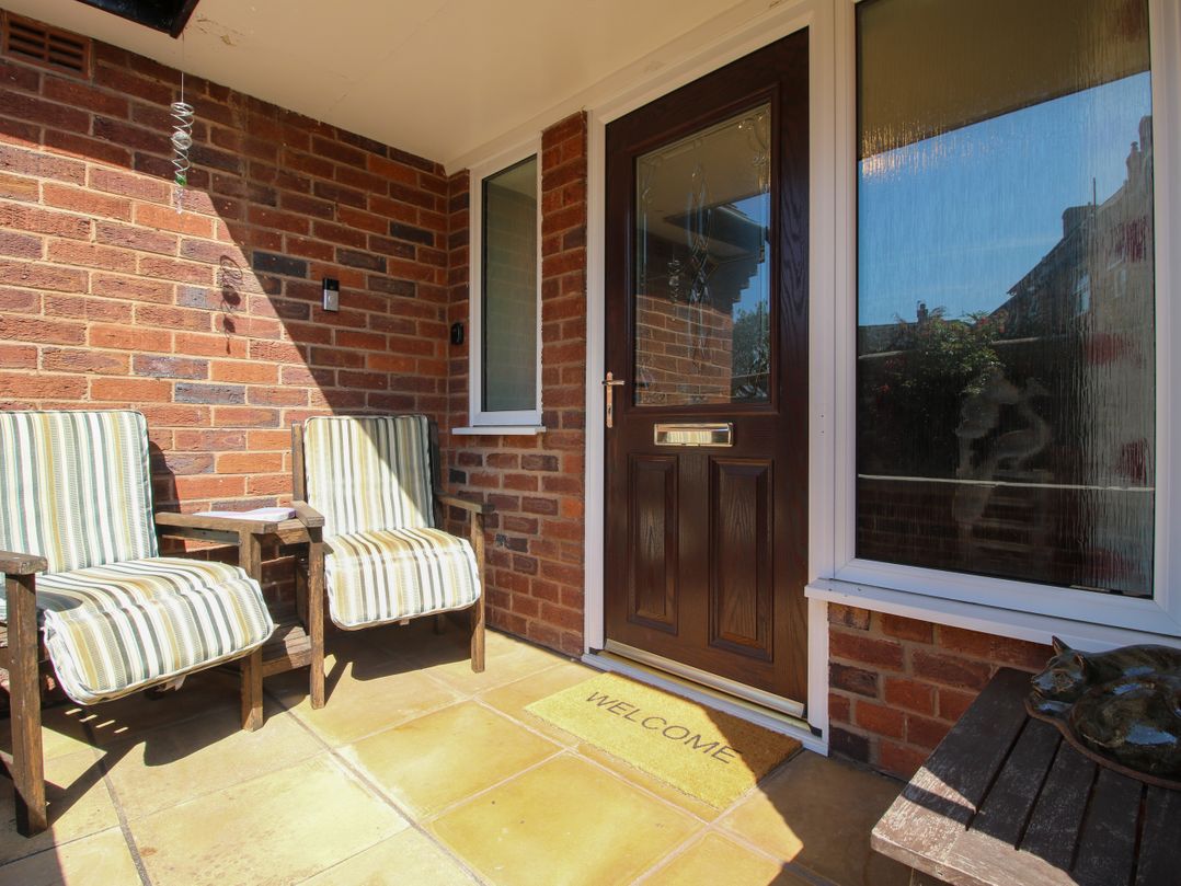 An outdoor area with chairs and a welcome mat at The Rumbles in Ludlow