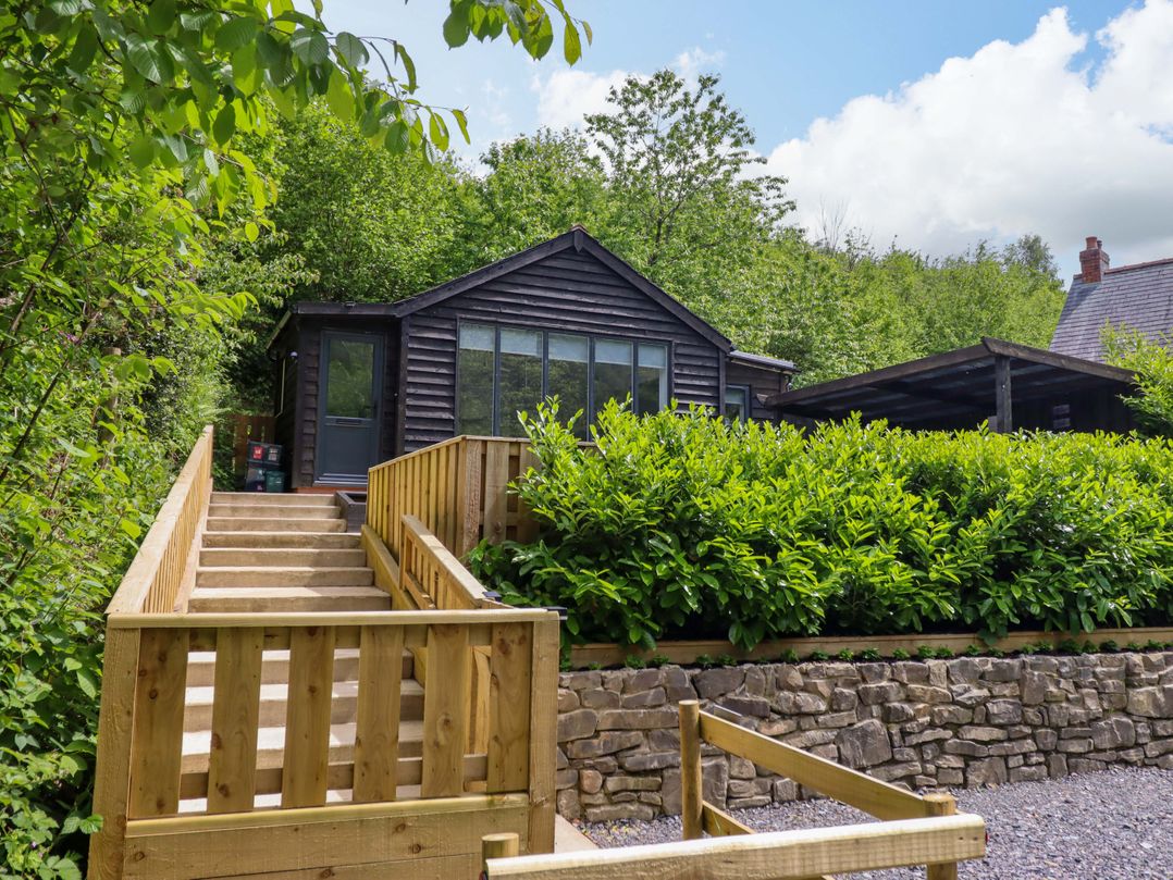 A house with steps leading up to it at Lodge at Nadur in Commins Coch near Machynlleth