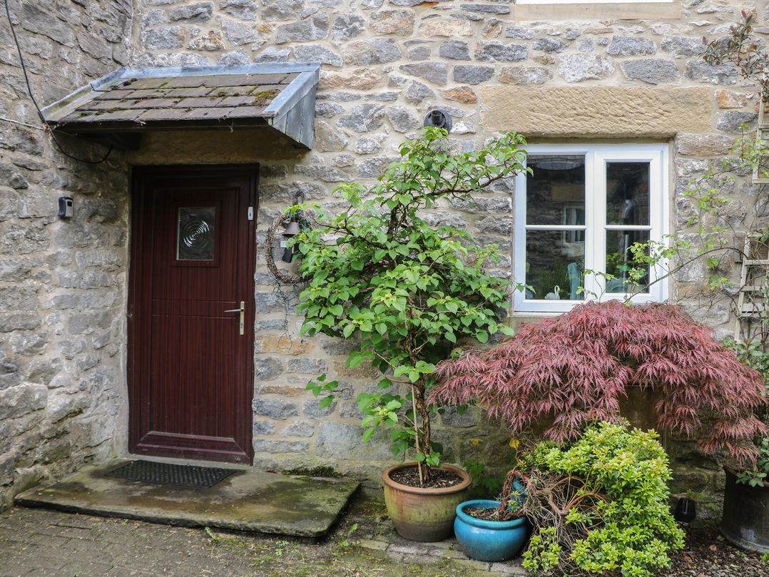 A door and window beside plants at Little Bargate in Castleton, Peak District