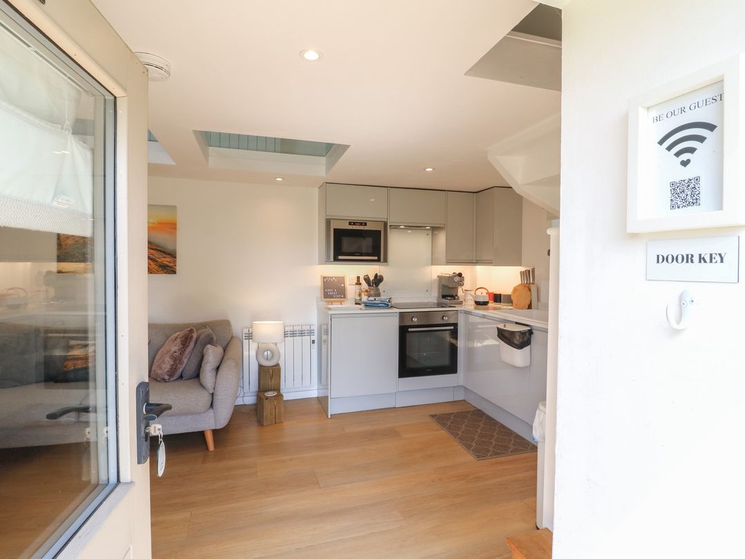 A kitchen with a couch in view at Little Barn in Grindon