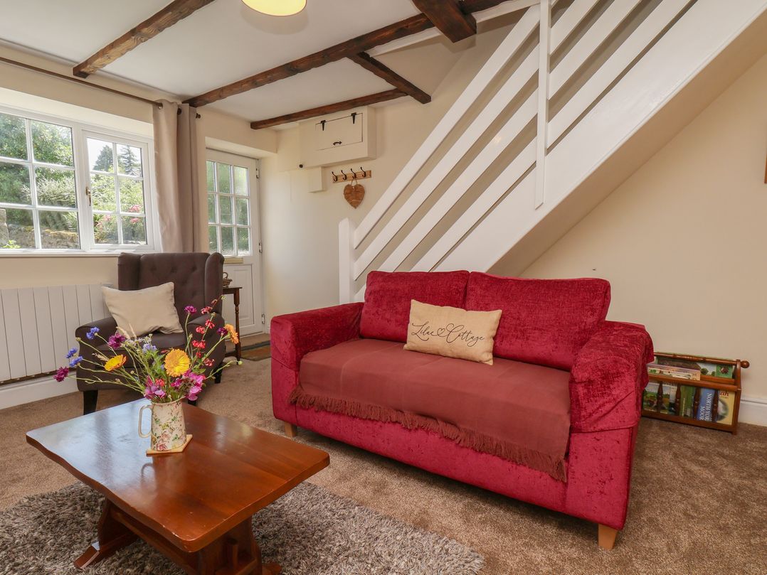 A living room with a sofa and an armchair at 4 Lilac Cottages Ainthorpe