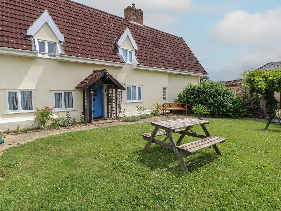 A garden with a house and outdoor seating at Driftway Stables Retreat, Diss