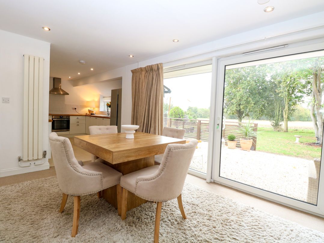 A dining room with a table and chairs at Three Ways South Lopham near Garboldisham