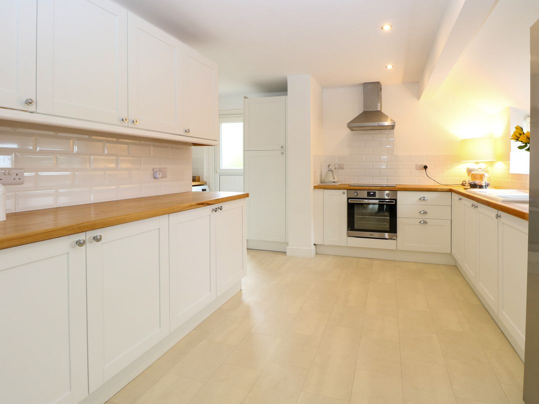 A kitchen with cabinets and appliances at Three Ways in South Lopham near Garboldisham