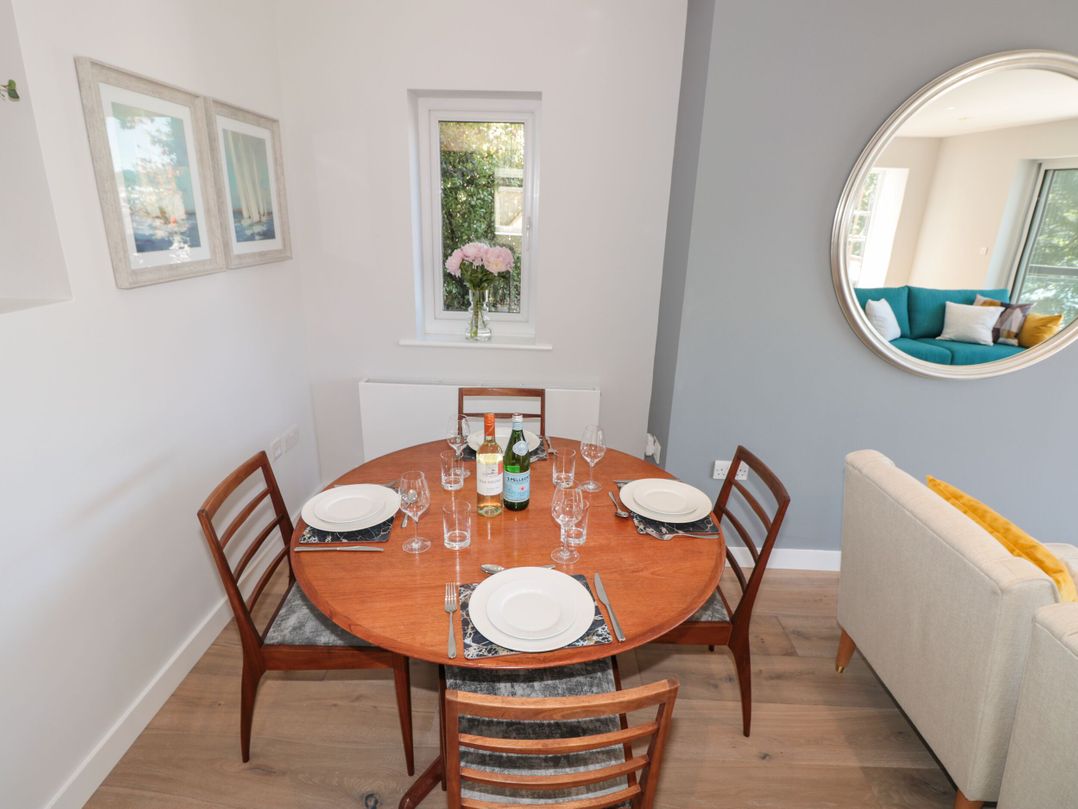 A dining room with a table set for a meal at Galvayne in Dartmouth