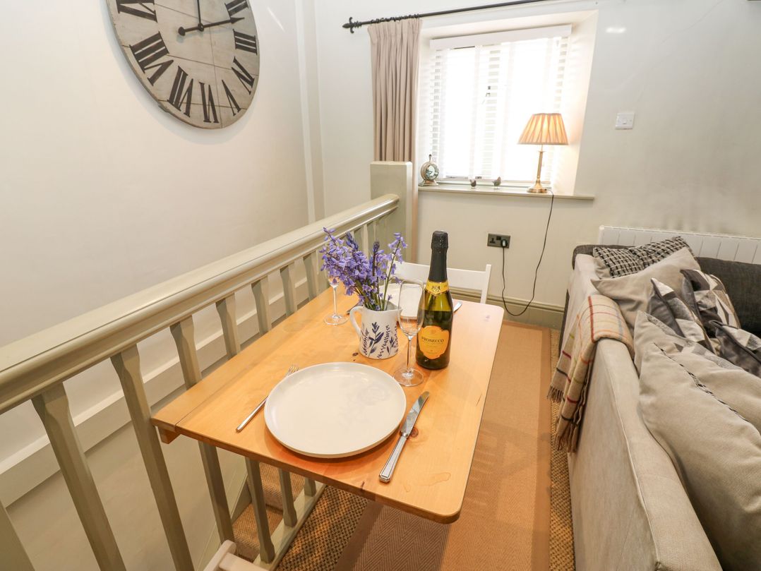 A dining area with a table set for two at In & Out Cottage Leyburn
